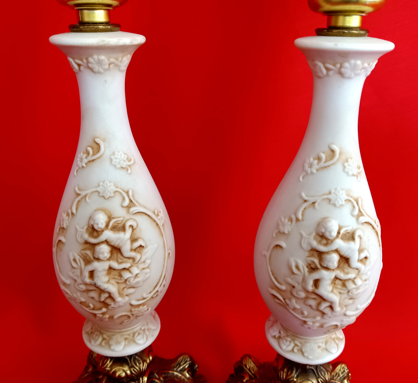 Pair Bisque Porcelain Mid Century Accent Table Lamps Off White w/ Embossed Cherubs/Angels Gold Cast Brass Footed Base Rococo Style Retro