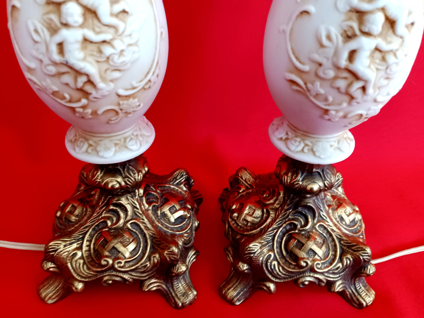 Pair Bisque Porcelain Mid Century Accent Table Lamps Off White w/ Embossed Cherubs/Angels Gold Cast Brass Footed Base Rococo Style Retro