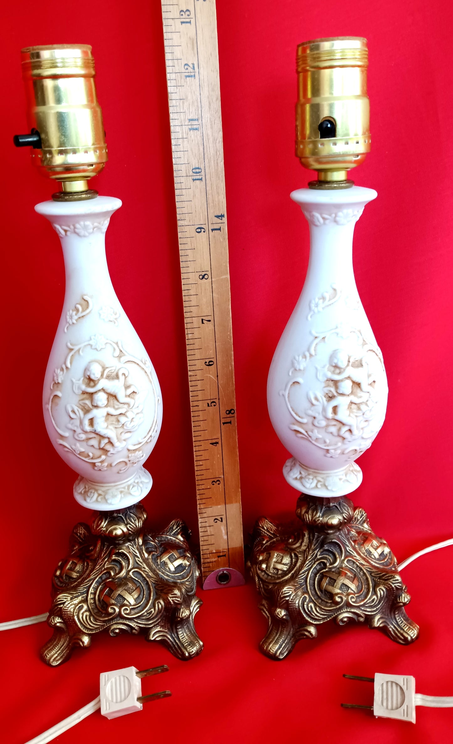 Pair Bisque Porcelain Mid Century Accent Table Lamps Off White w/ Embossed Cherubs/Angels Gold Cast Brass Footed Base Rococo Style Retro