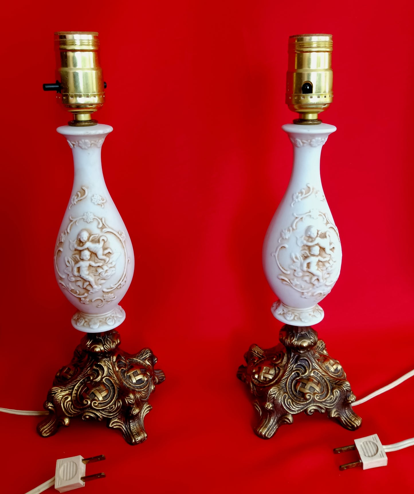 Pair Bisque Porcelain Mid Century Accent Table Lamps Off White w/ Embossed Cherubs/Angels Gold Cast Brass Footed Base Rococo Style Retro
