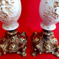 Pair Bisque Porcelain Mid Century Accent Table Lamps Off White w/ Embossed Cherubs/Angels Gold Cast Brass Footed Base Rococo Style Retro